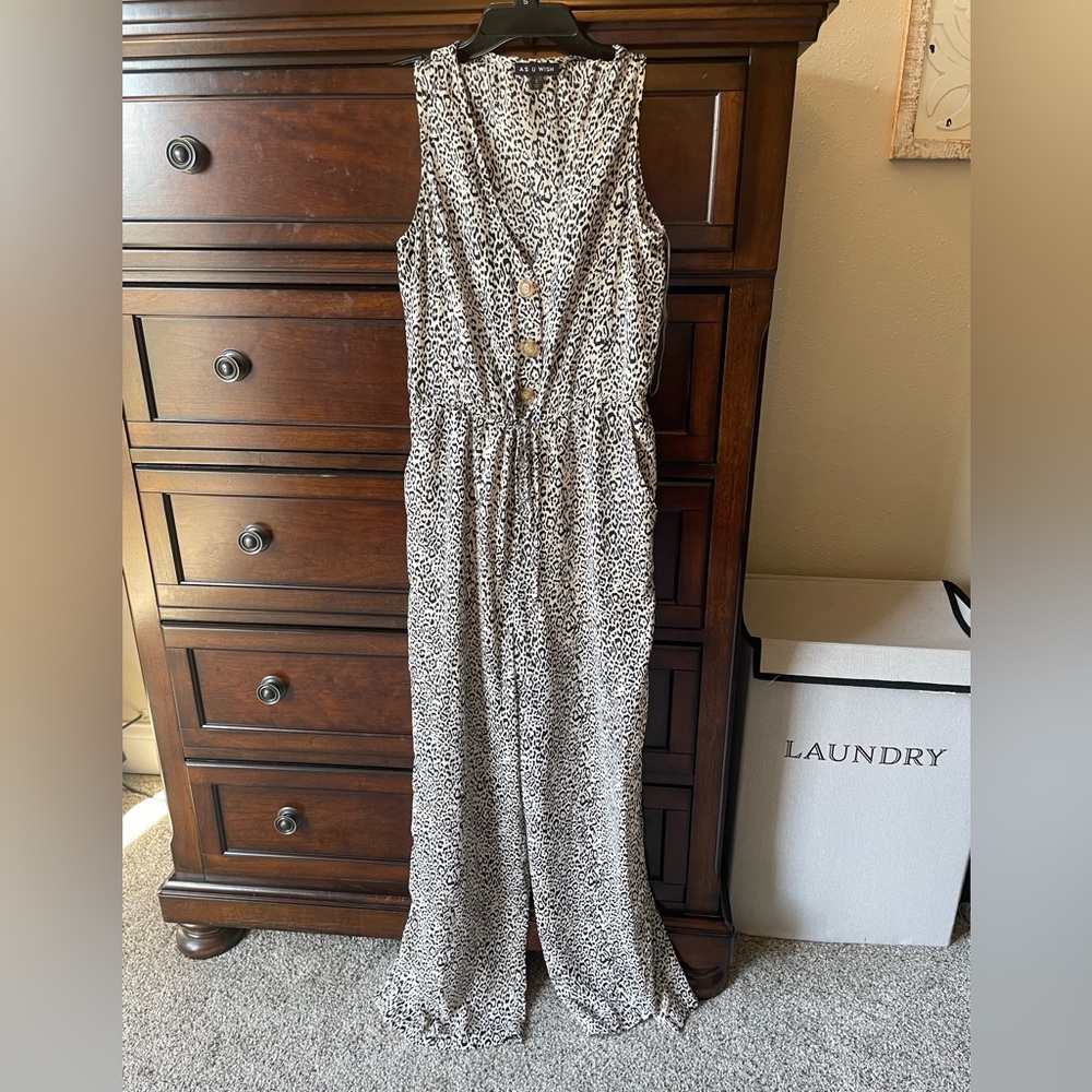 Animal print jumpsuit with buttons and a tie waist.